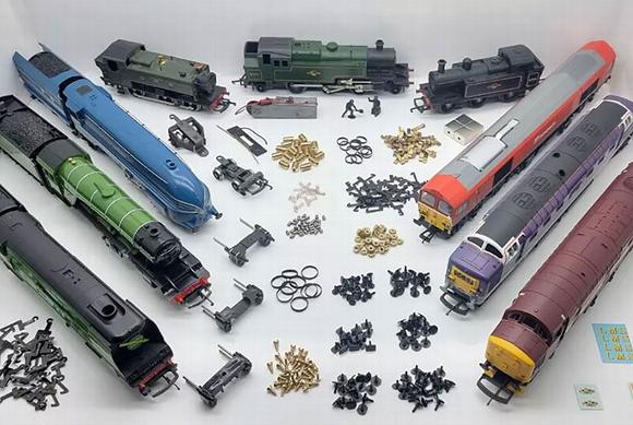 spare train parts and carnages laid out on table